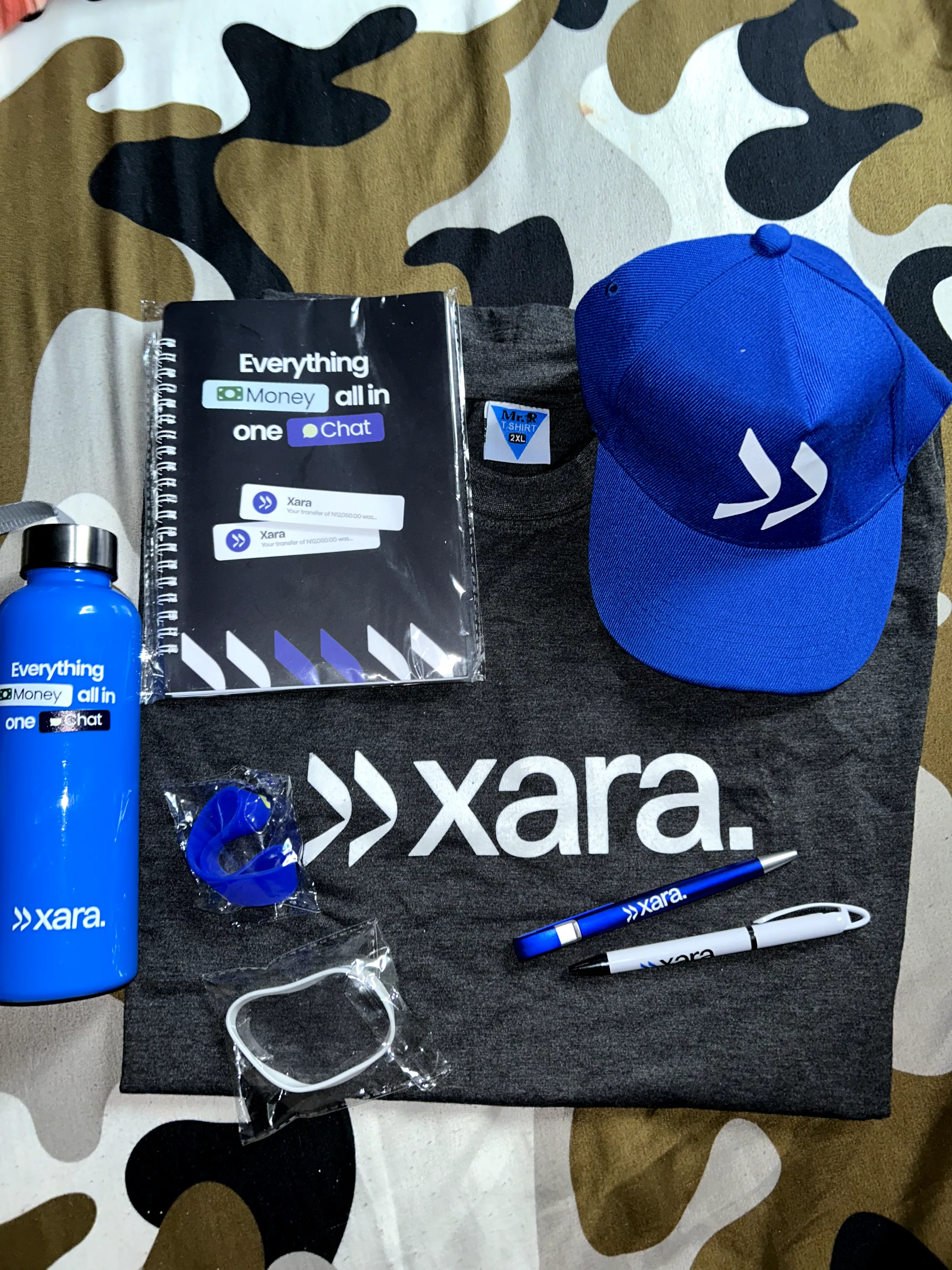 Xara brand kit — t-shirt, cap, notebook, pen, water bottle